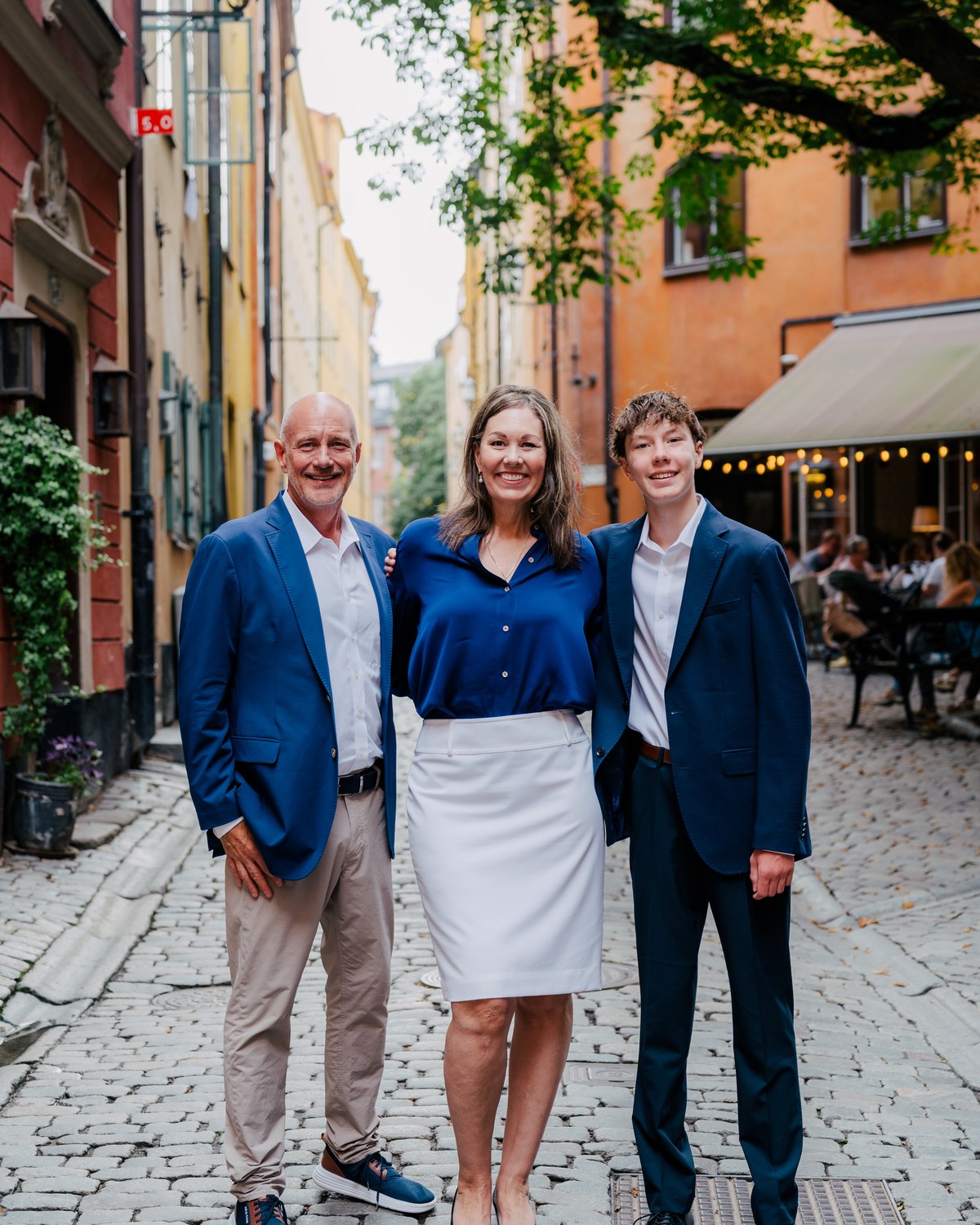 Katherine with her husband and son on a cobbled street in Stockholm's old town