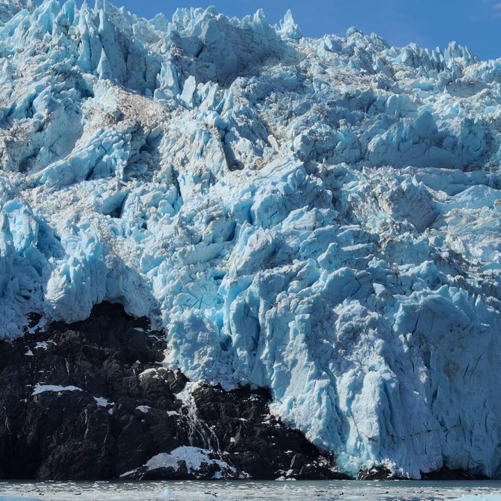 Blue glacier ice meeting the sea in Alaska