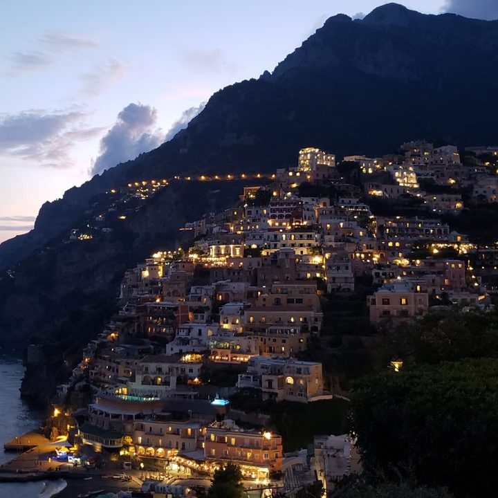 The Amalfi coast at dusk, village lights above the water