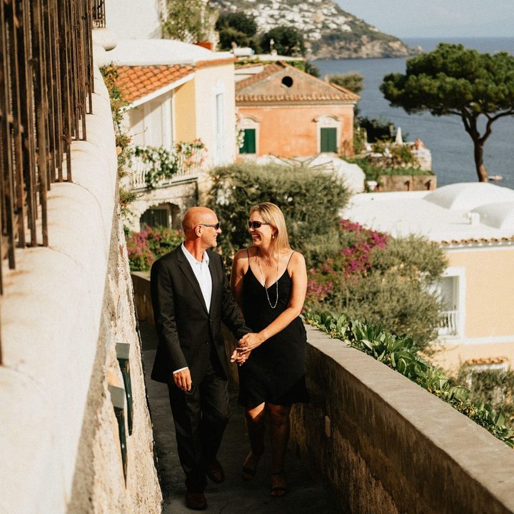 A couple on a Positano terrace above the Amalfi coast, photographed by Flytographer